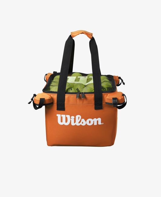 The Wilson Teaching Cart Bag in orange with tennis balls inside for display purposes available for sale at GSM Sports.