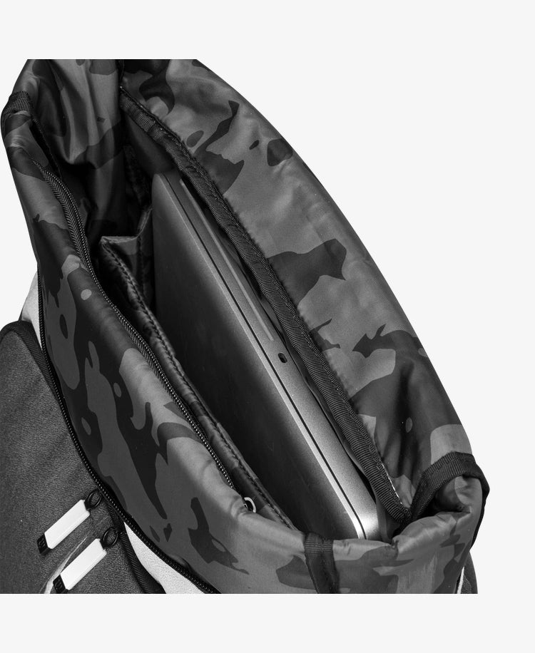 The Wilson Womens Backpack in cream, forest green and black with a laptop inside for display purposes which is available for sale at GSM Sports.