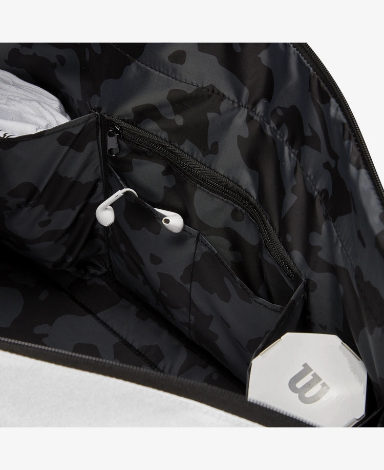 The Wilson Womens Racket Bag in cream, forest grey and black with tennis equipment inside for display purposes which is available for sale at GSM Sports